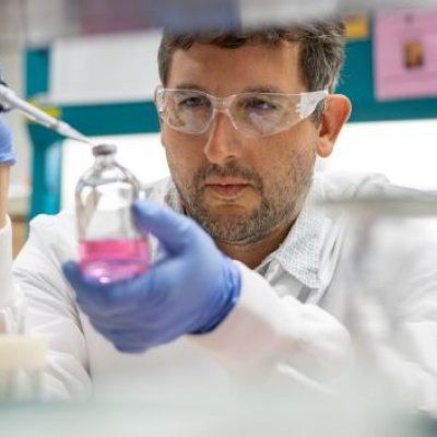 Researcher pipetting liquid in a lab